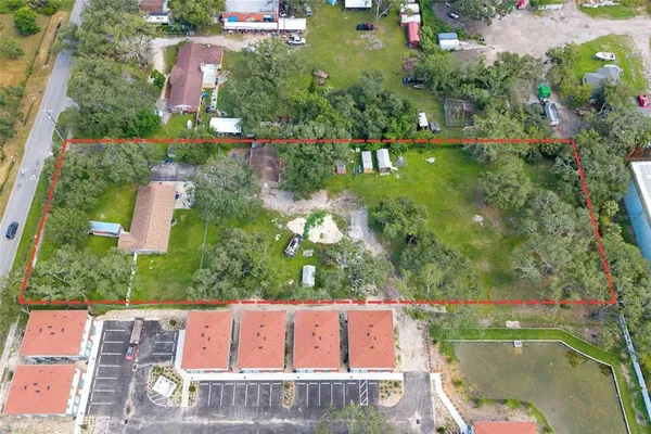 an aerial view of residential houses with outdoor space and street view