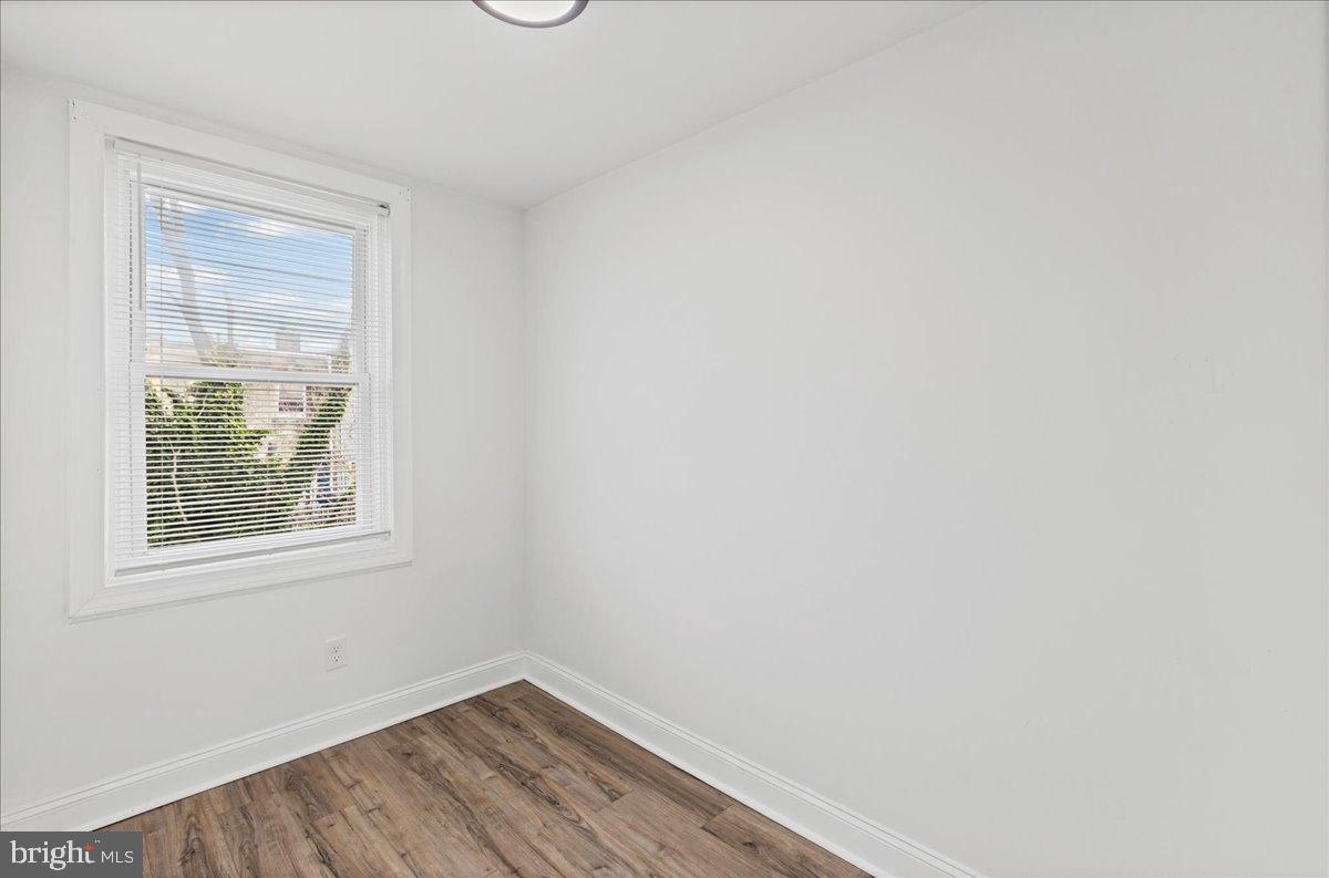 2637 Carroll Street Philadelphia, PA 19142 - Photo 12 of 31 a view of an empty room with wooden floor and a window