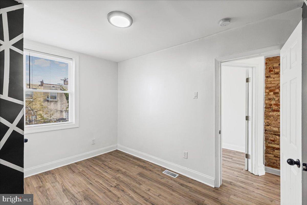 2637 Carroll Street Philadelphia, PA 19142 - Photo 16 of 31 an empty room with wooden floor and windows