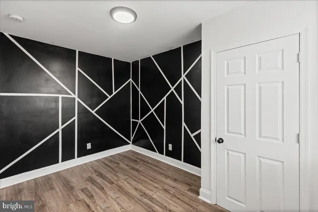 a view of a room with wooden floor