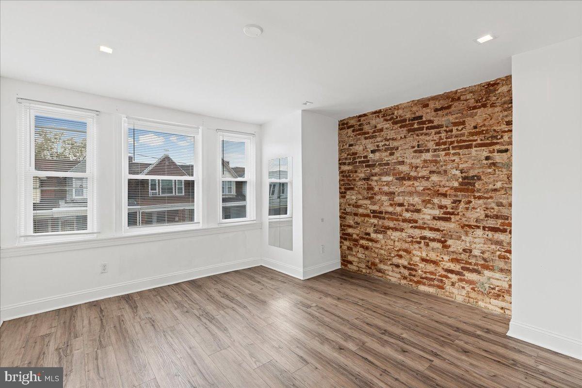 2637 Carroll Street Philadelphia, PA 19142 - Photo 19 of 31 wooden floor in an empty room with a window