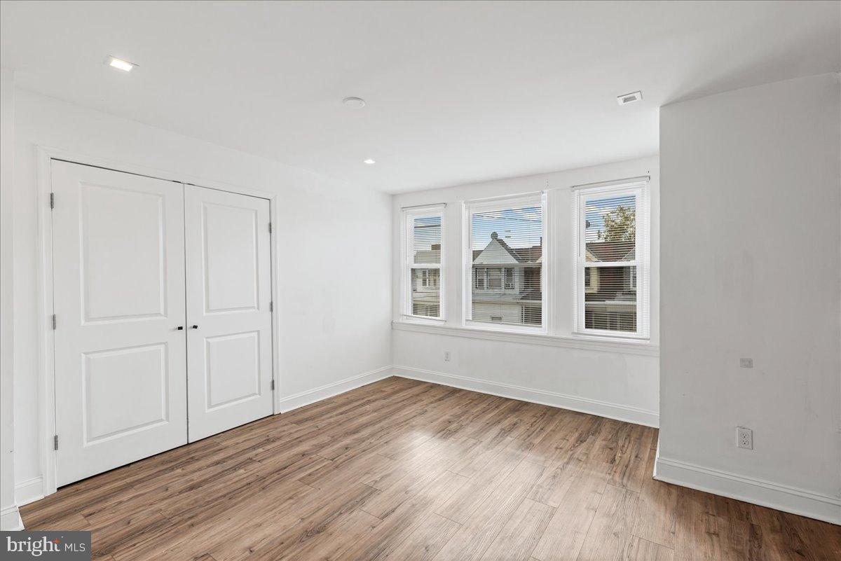 2637 Carroll Street Philadelphia, PA 19142 - Photo 20 of 31 a view of an empty room with wooden floor and a window