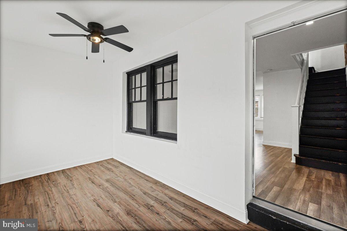 2637 Carroll Street Philadelphia, PA 19142 - Photo 3 of 31 a view of a room with wooden floor staircase and a ceiling fan