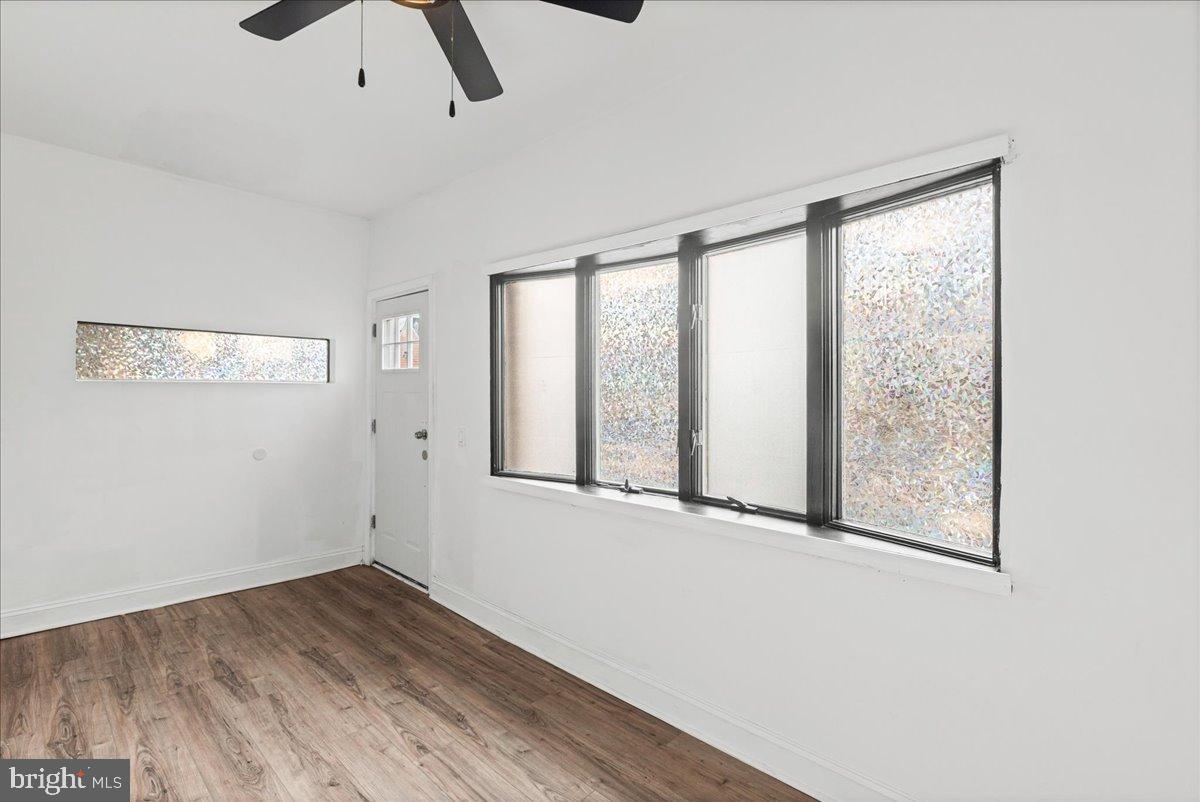 2637 Carroll Street Philadelphia, PA 19142 - Photo 4 of 31 an empty room with wooden floor and windows
