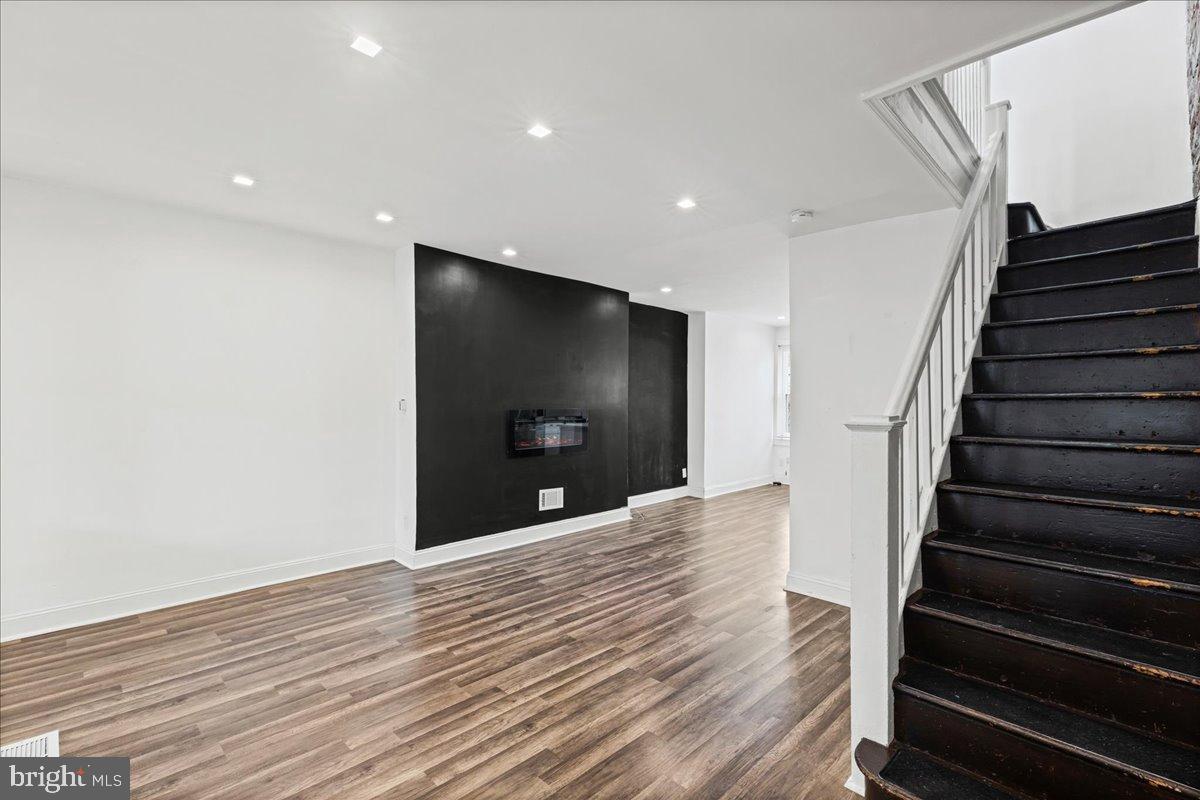 2637 Carroll Street Philadelphia, PA 19142 - Photo 5 of 31 a view of a livingroom with wooden floor and stairs
