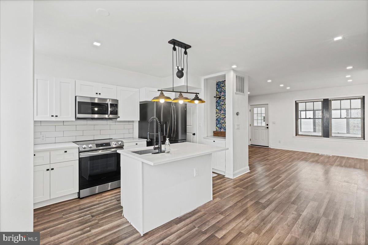 2637 Carroll Street Philadelphia, PA 19142 - Photo 9 of 31 a kitchen with stainless steel appliances a stove top oven a sink and a refrigerator