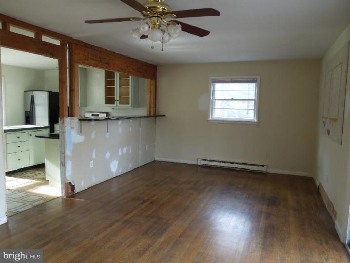 953 Pine Grove Road Bluemont, VA 20135 - Photo 12 of 25 an empty room with wooden floor fan and windows