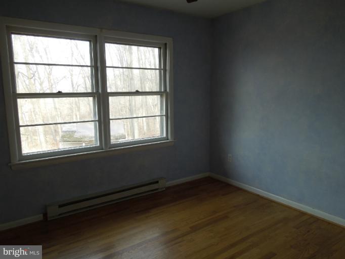 953 Pine Grove Road Bluemont, VA 20135 - Photo 7 of 25 an empty room with wooden floor and windows