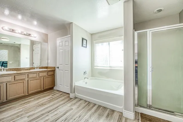 a spacious bathroom with a tub shower and sink