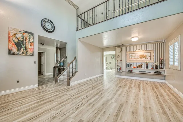 a view of a livingroom with wooden floor and a ceiling fan