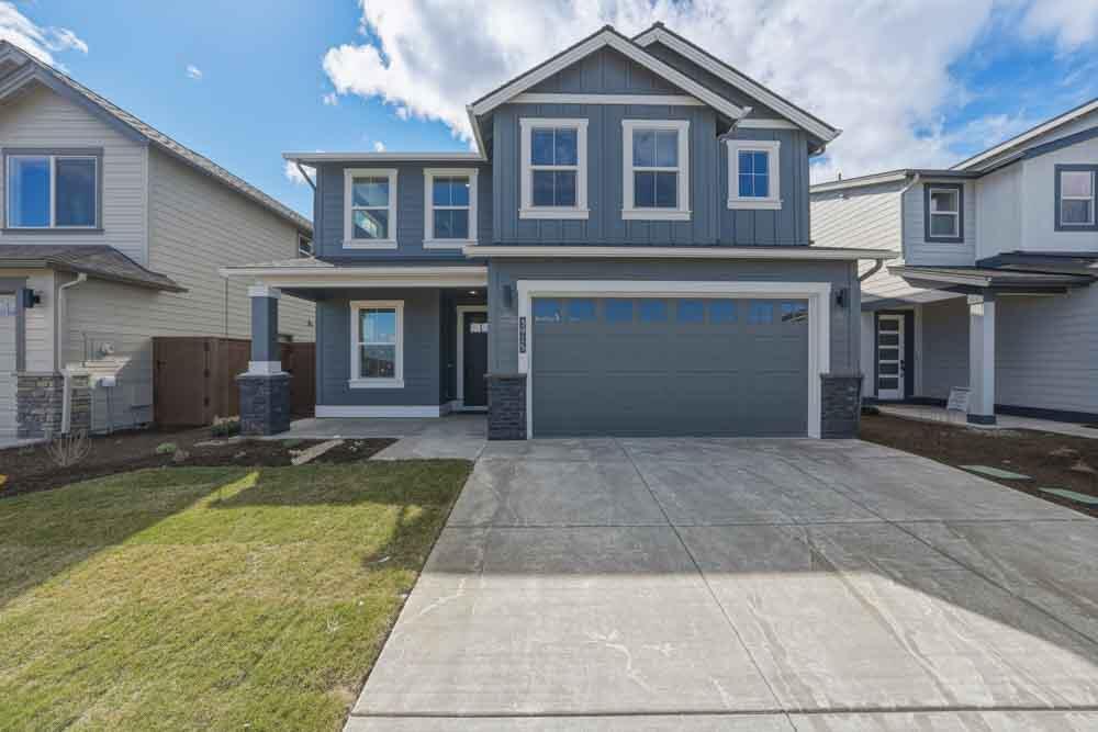 3915 Northeast Oakside Loop Bend, OR 97701 - Photo 1 of 27 a front view of a house with a yard and garage