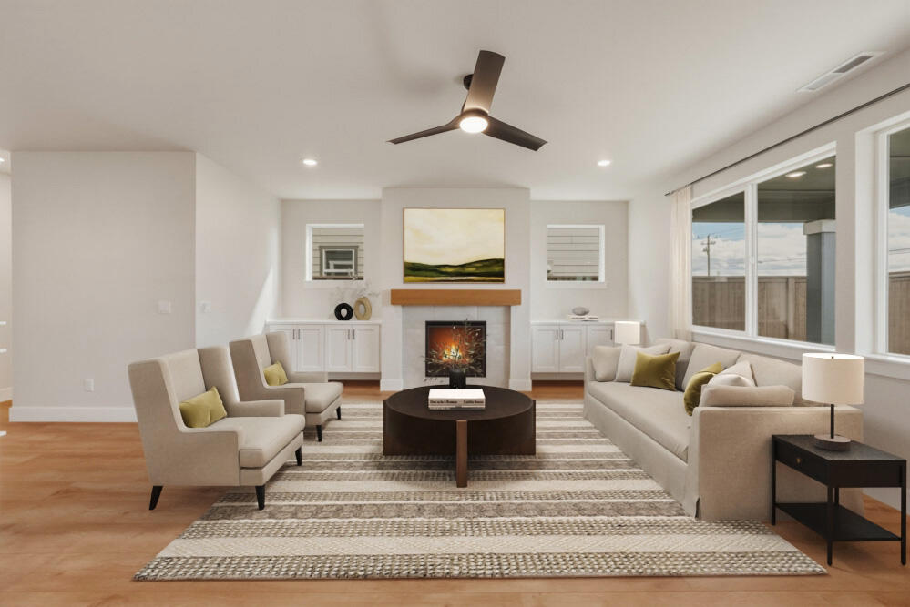 3915 Northeast Oakside Loop Bend, OR 97701 - Photo 2 of 27 a living room with furniture a fireplace and a large window