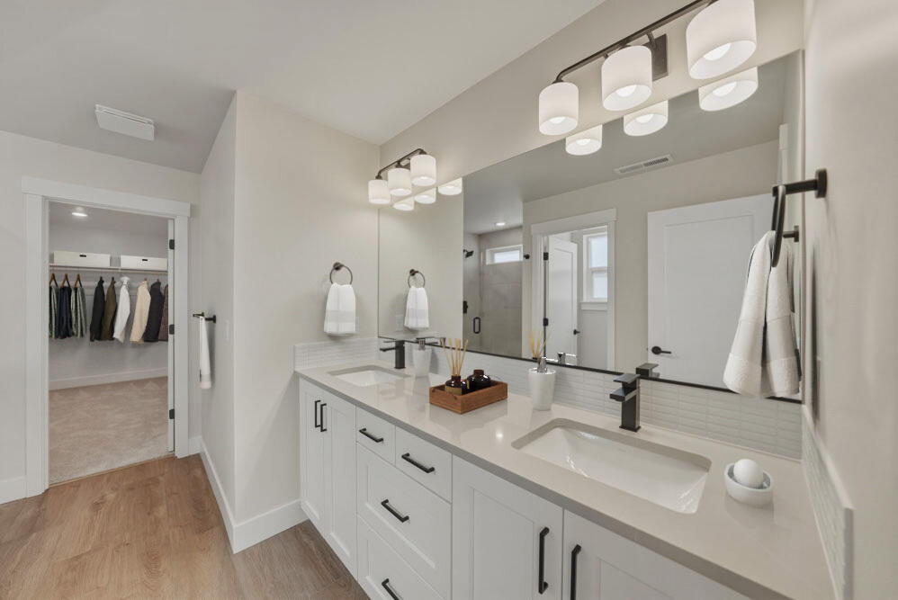 3915 Northeast Oakside Loop Bend, OR 97701 - Photo 6 of 27 a bathroom with a double vanity sink and a mirror