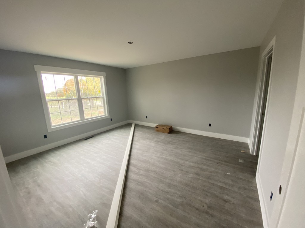 105 Switchboard Road Portland, TN 37148 - Photo 3 of 6 an empty room with wooden floor and windows