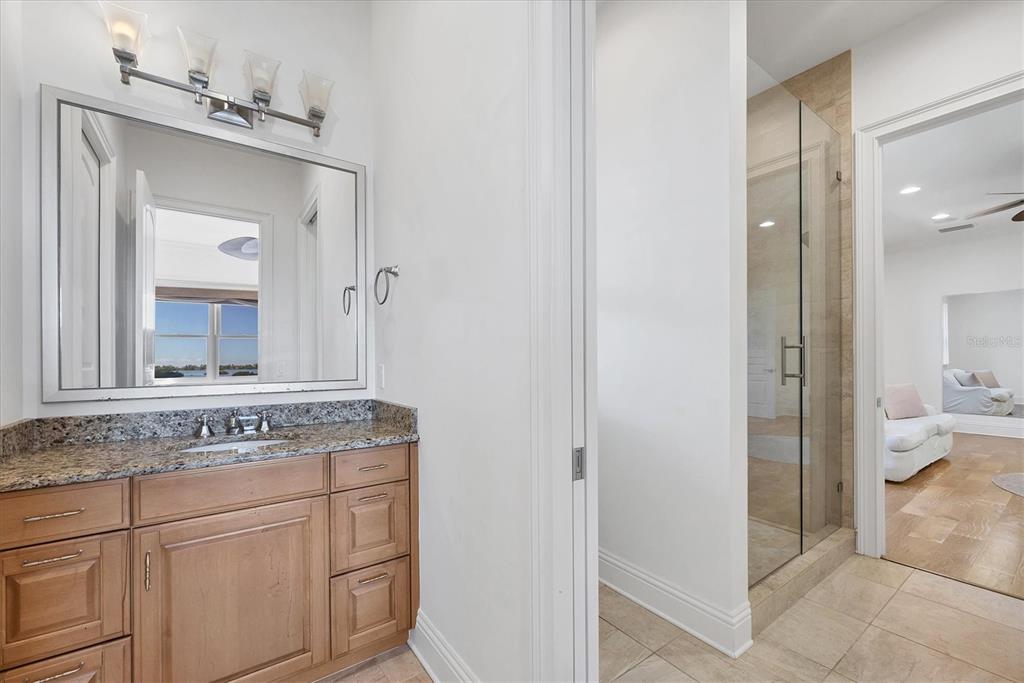 730 Sarabay Road Osprey, FL 34229 - Photo 21 of 95 a bathroom with a granite countertop sink mirror and toilet
