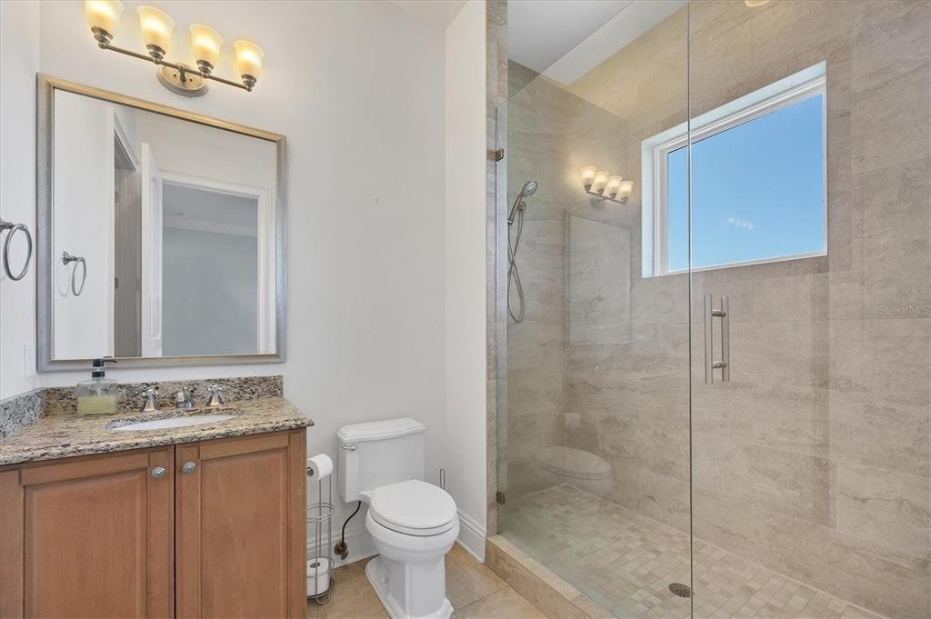 730 Sarabay Road Osprey, FL 34229 - Photo 31 of 95 a bathroom with a granite countertop sink toilet and shower