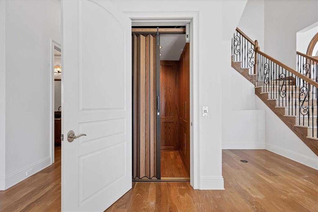 730 Sarabay Road Osprey, FL 34229 - Photo 37 of 95 a view of a hallway with wooden floor and staircase