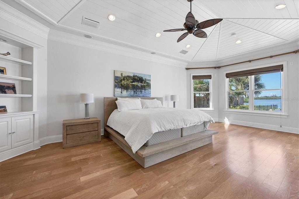 730 Sarabay Road Osprey, FL 34229 - Photo 54 of 95 a spacious bedroom with a bed and a chandelier