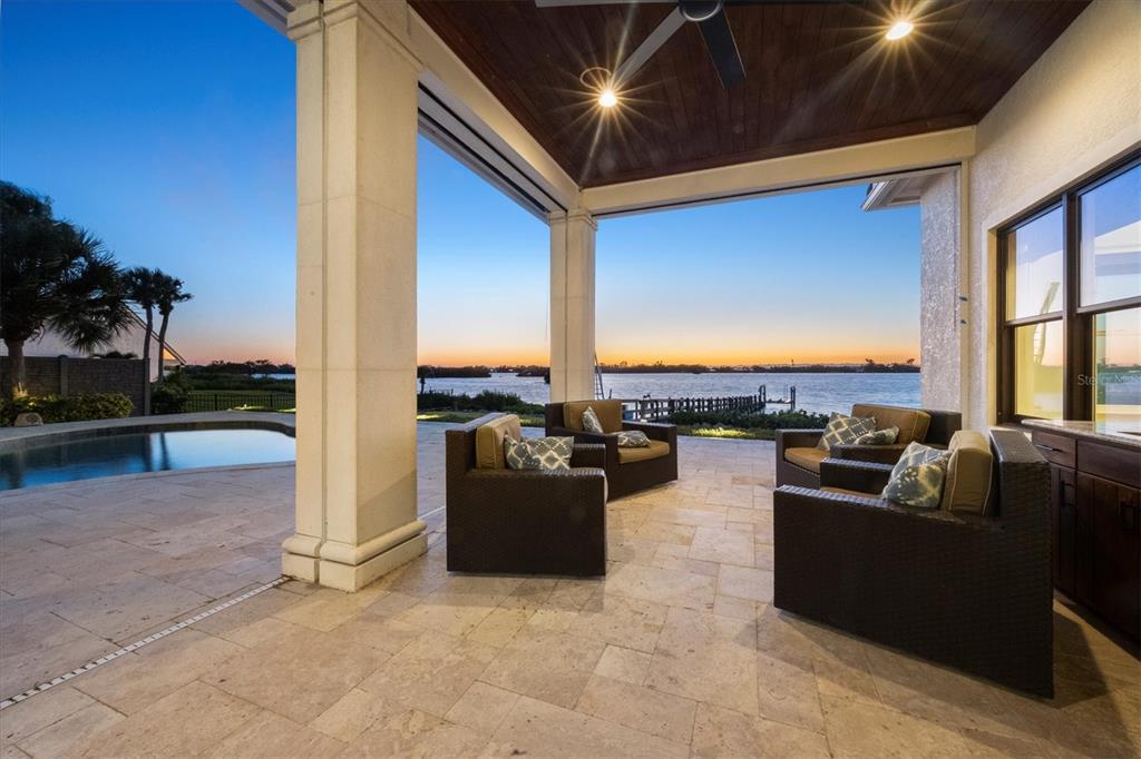 730 Sarabay Road Osprey, FL 34229 - Photo 83 of 95 a living room with patio furniture and a floor to ceiling window