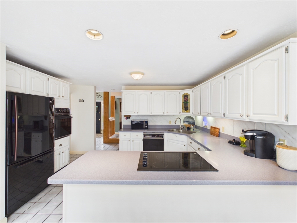 50 Prospect Avenue Hull, MA 02045 - Photo 11 of 41 a kitchen that has a lot of cabinets a sink and appliances