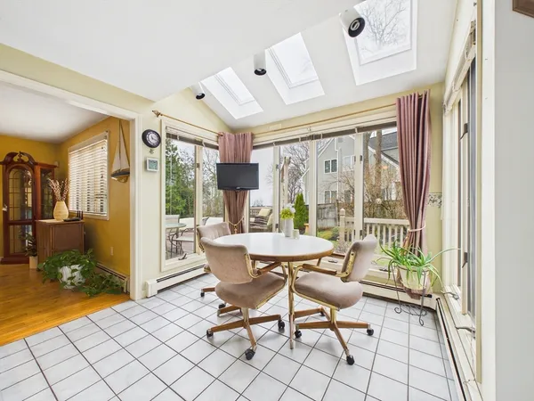 a dining room with furniture wooden floor and a rug