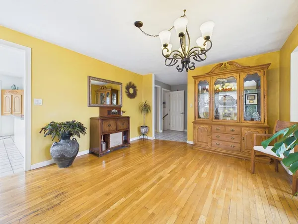 a view of a livingroom with furniture a chandelier