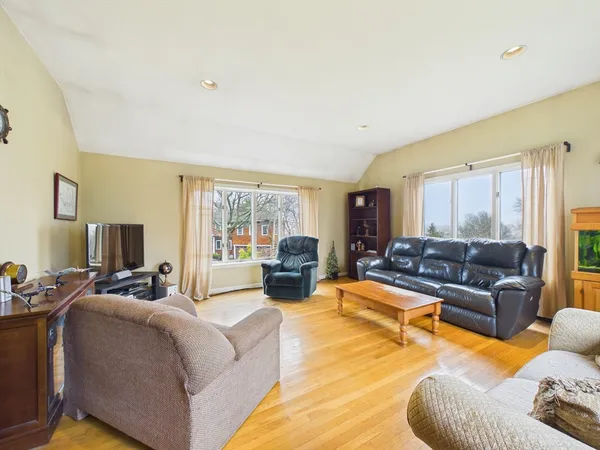 a living room with furniture large windows and a flat screen tv