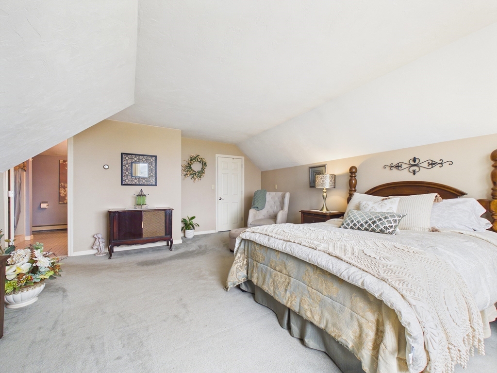 50 Prospect Avenue Hull, MA 02045 - Photo 21 of 41 a spacious bedroom with a bed and chair