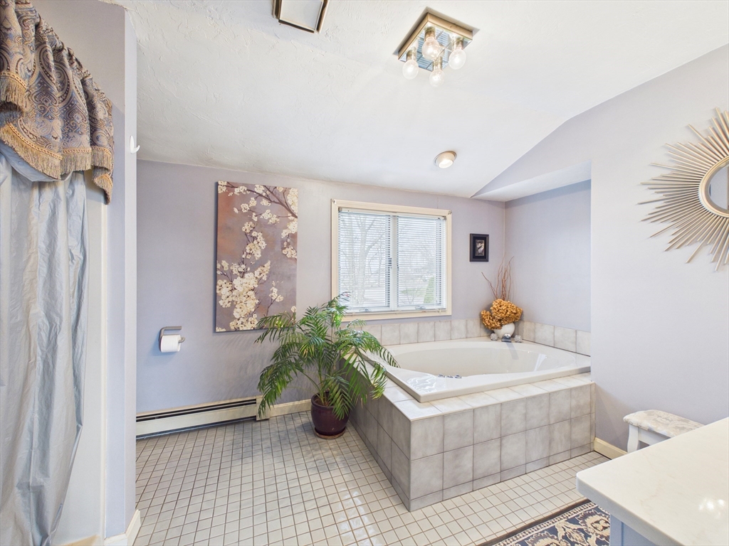 50 Prospect Avenue Hull, MA 02045 - Photo 23 of 41 a white bath tub sitting in a bathroom next to a window
