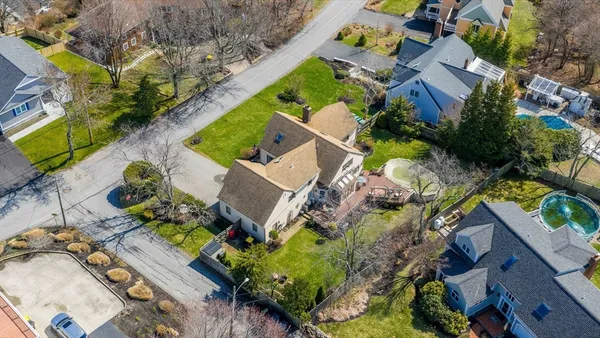 an aerial view of a house with a yard