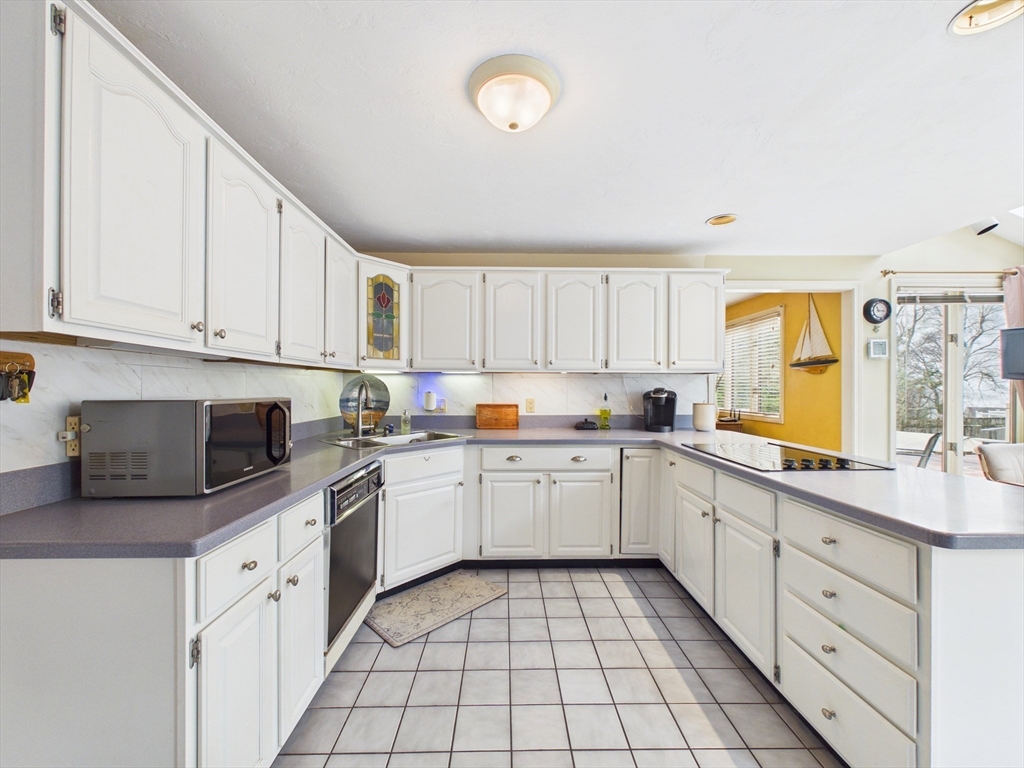 50 Prospect Avenue Hull, MA 02045 - Photo 9 of 41 a kitchen with cabinets appliances a sink and a window