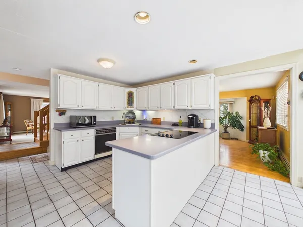 a kitchen with a sink window and cabinets