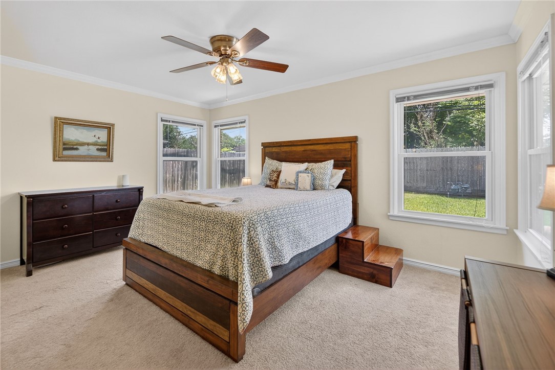 609 Peerman Place Corpus Christi, TX 78411 - Photo 16 of 36 a bedroom with a bed and a window