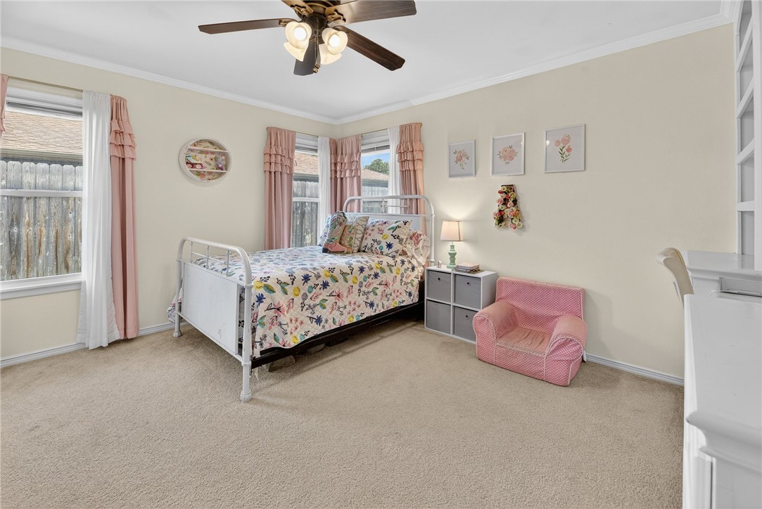 609 Peerman Place Corpus Christi, TX 78411 - Photo 19 of 36 a bedroom with a bed and a chandelier