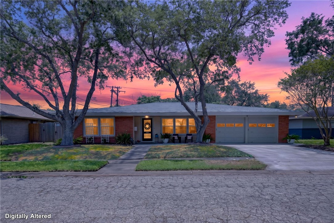 609 Peerman Place Corpus Christi, TX 78411 - Photo 2 of 36 a front view of a house with a yard and trees