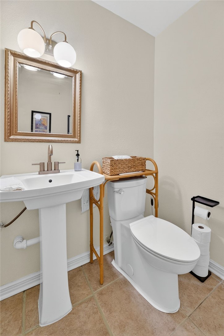 609 Peerman Place Corpus Christi, TX 78411 - Photo 21 of 36 a bathroom with a sink toilet and mirror