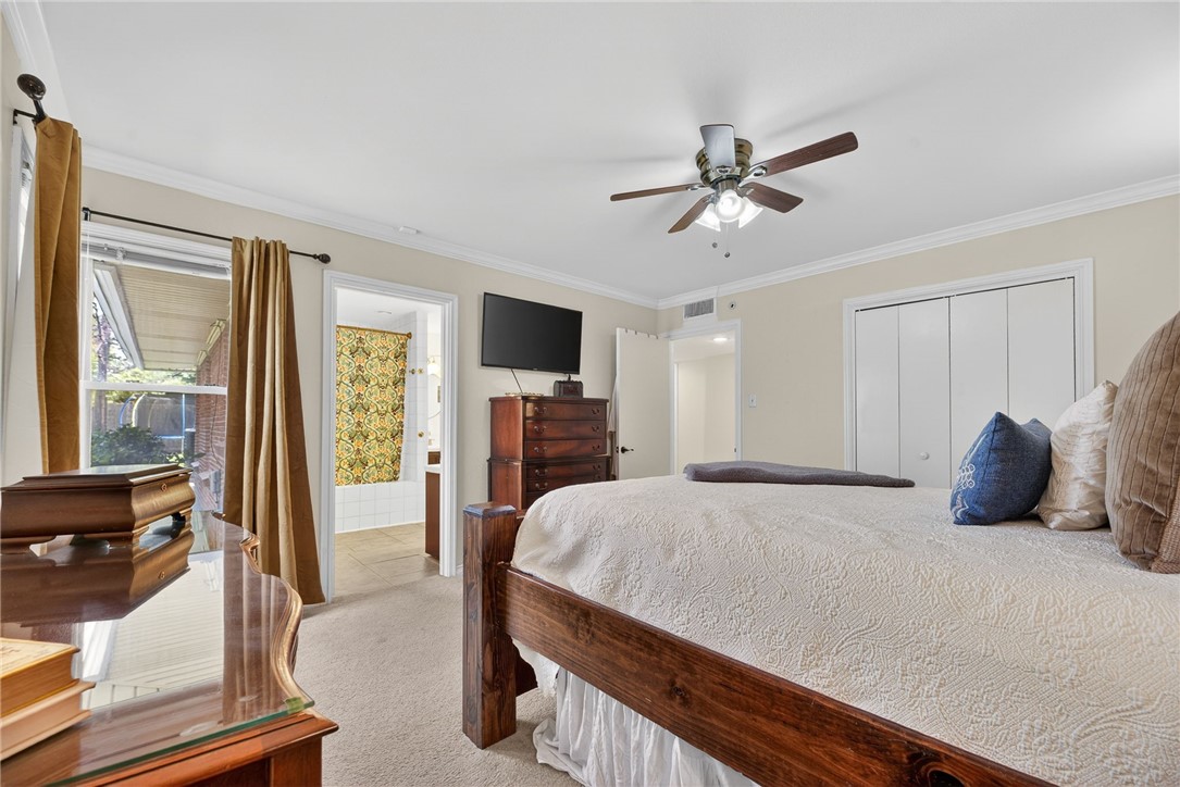 609 Peerman Place Corpus Christi, TX 78411 - Photo 24 of 36 a bedroom with a bed and a chandelier