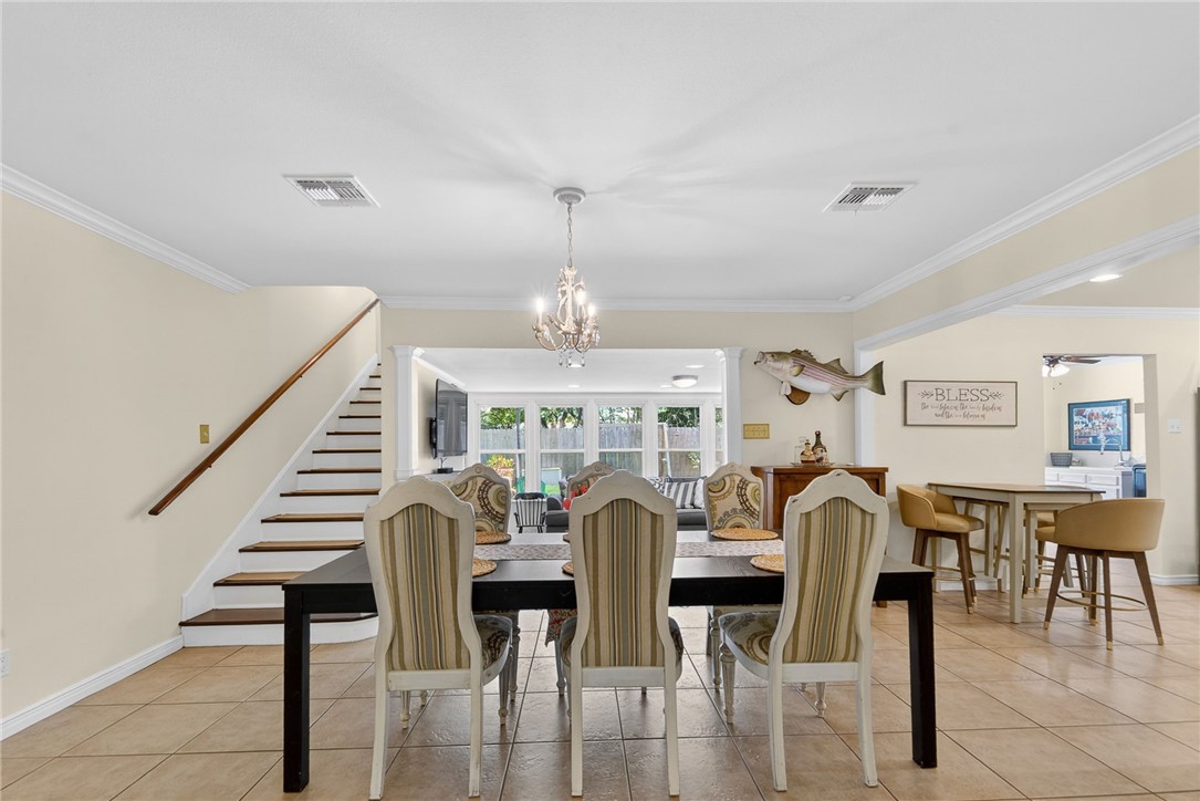 609 Peerman Place Corpus Christi, TX 78411 - Photo 7 of 36 a view of a dining room with furniture and wooden floor