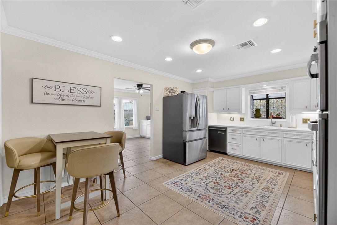 609 Peerman Place Corpus Christi, TX 78411 - Photo 9 of 36 a kitchen with a refrigerator and chairs