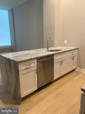 a kitchen with granite countertop a sink and cabinets