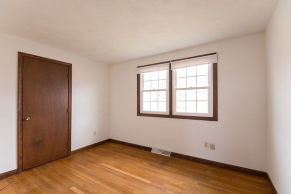 320 Quincy Street Fall River, MA 02720 - Photo 14 of 21 an empty room with wooden floor and windows