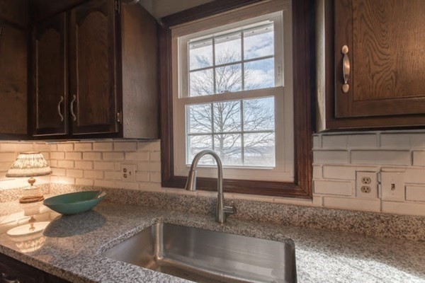 320 Quincy Street Fall River, MA 02720 - Photo 8 of 21 a kitchen with granite countertop a sink a stove and cabinets