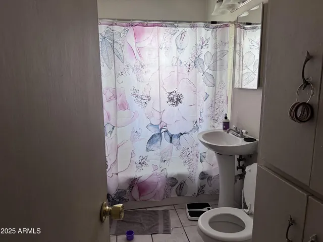 a view of a hallway and a room with windows