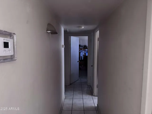 a kitchen with a refrigerator and cabinets