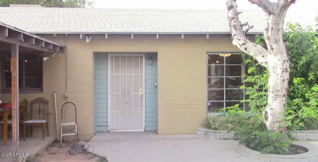 a couple of potted plants in front of door
