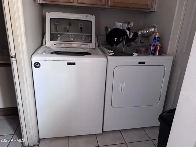 a kitchen with a refrigerator and a stove top oven