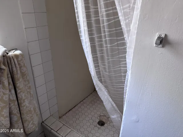 a view of a yard with wooden fence