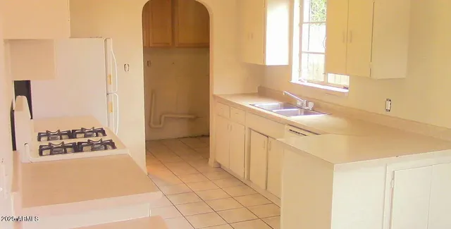 a kitchen with a stove and a refrigerator