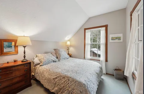 a bedroom with a large bed and walk in closet