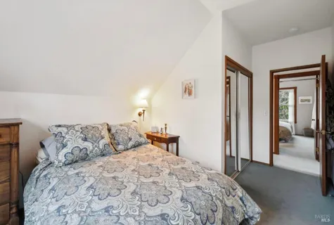 a living room with furniture and a book shelf
